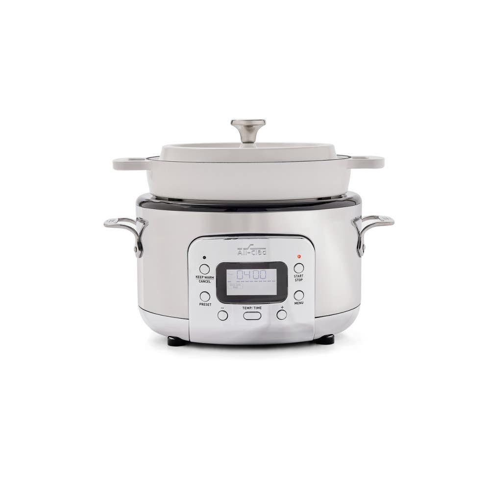 All-Clad SD9221U0 five-quart digital slow cooker with white cast-iron pot and lid on a stainless electric base